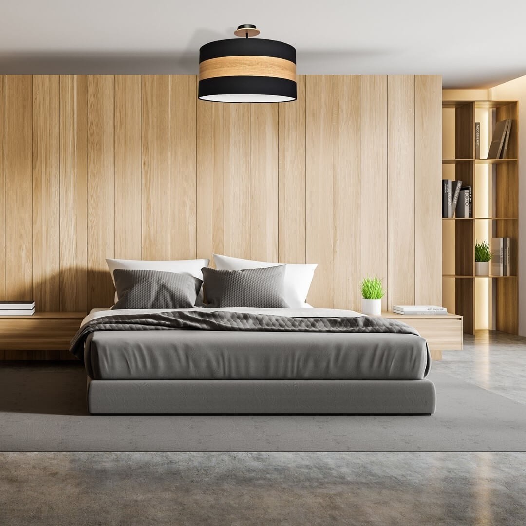 Czarna lampa z elementami drewna w sypialni