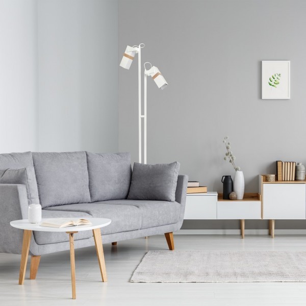 Biała lampa podłogowa MiLAGRO stojąca w salonie przy kanapie
