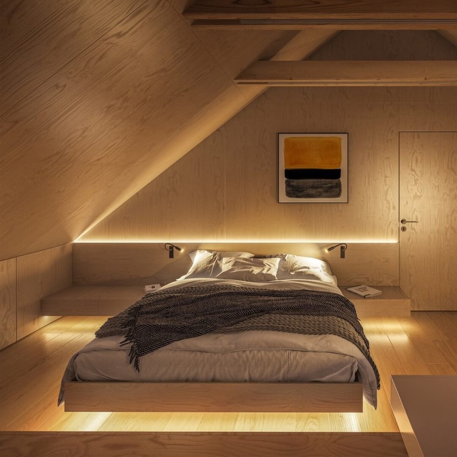 Łóżko w sypialni oświetlone taśmami LED 